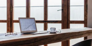 Laptop on a desk with a financial graph analyzing DSCR loan requirements.