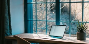 Laptop on a desk displaying a California FHA loan calculator.