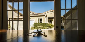 House keys on a table for a new home, purchased using the new lending rules for renting out your previous home.