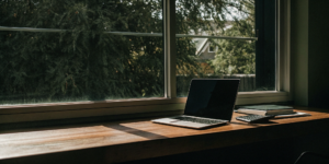 Calculating the maximum debt to income ratio for a USDA loan with a laptop, calculator, and notes.