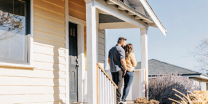 First time home buyers in California on the porch of their new home, purchased with an FHA loan.