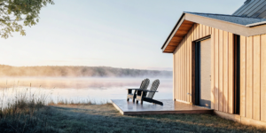 Financing a modern vacation home on a lake with two chairs on the deck.